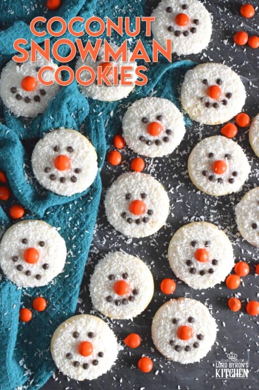 Coconut Snowman Cookies are simply adorable! They're also very easy to make, inexpensive, and delicious too! The base of the cookie melts in your mouth! Using mini chocolate chips for his eyes and mouth, and an orange candy-coated chocolate for his nose, these cookies are almost too cute to eat! #snowman #coconut #cookies #sugarcookies