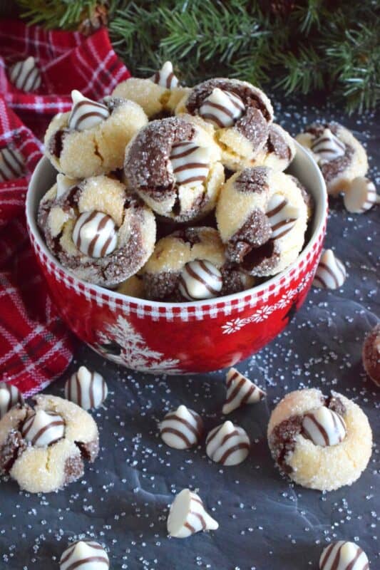 A deliciously decadent half vanilla and half chocolate cookie, coated in sugar, and topped with a chocolate kiss, Hershey’s Hugs and Kiss Cookies are a perfect holiday treat that everyone will love! These are quick and easy - no need to chill the cookie dough before baking either! Don't they look absolutely adorable!? #hershey #hugsandkisses #christmas #cookies