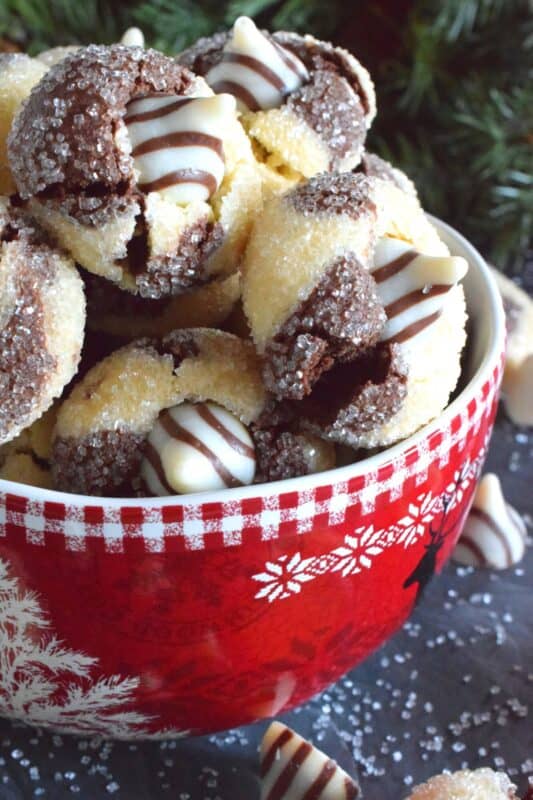 A deliciously decadent half vanilla and half chocolate cookie, coated in sugar, and topped with a chocolate kiss, Hershey’s Hugs and Kiss Cookies are a perfect holiday treat that everyone will love! These are quick and easy - no need to chill the cookie dough before baking either! Don't they look absolutely adorable!? #hershey #hugsandkisses #christmas #cookies