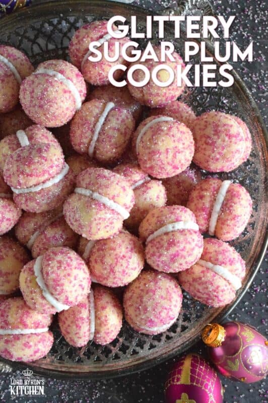These beautiful, shimmering, Glittery Sugar Plum Cookies are the epitome of priceless luxury on a dollar store budget.The cookies are baked with a sparkling, sugary coating and sandwiched together with an easy, sweet frosting. One bite and you'll certainly have visions of these sugar plums dancing in your head on Christmas Eve night! #sugarplums #christmas #baking #cookies #glitter