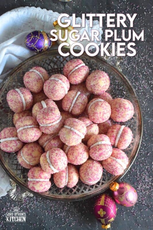 These beautiful, shimmering, Glittery Sugar Plum Cookies are the epitome of priceless luxury on a dollar store budget.The cookies are baked with a sparkling, sugary coating and sandwiched together with an easy, sweet frosting. One bite and you'll certainly have visions of these sugar plums dancing in your head on Christmas Eve night! #sugarplums #christmas #baking #cookies #glitter