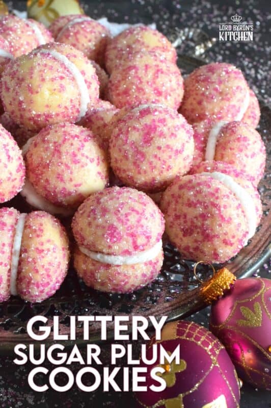 These beautiful, shimmering, Glittery Sugar Plum Cookies are the epitome of priceless luxury on a dollar store budget.The cookies are baked with a sparkling, sugary coating and sandwiched together with an easy, sweet frosting. One bite and you'll certainly have visions of these sugar plums dancing in your head on Christmas Eve night! #sugarplums #christmas #baking #cookies #glitter