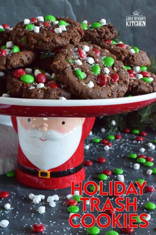 Holiday Trash Cookies are loaded with both milk and white chocolate chips, M&Ms, crushed pretzels, and marshmallow bits too! The cookie dough is prepared with brown sugar, which means these cookies are soft and moist on the inside, but they have a crisp exterior! Make a delightfully tasty gift by packaging these festive cookies up in boxes and tying them with a bright festive ribbon! #mandm #christmas #santa #cookies #trash