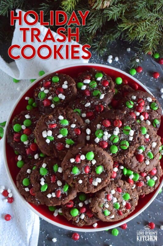 Holiday Trash Cookies are loaded with both milk and white chocolate chips, M&Ms, crushed pretzels, and marshmallow bits too! The cookie dough is prepared with brown sugar, which means these cookies are soft and moist on the inside, but they have a crisp exterior! Make a delightfully tasty gift by packaging these festive cookies up in boxes and tying them with a bright festive ribbon! #mandm #christmas #santa #cookies #trash