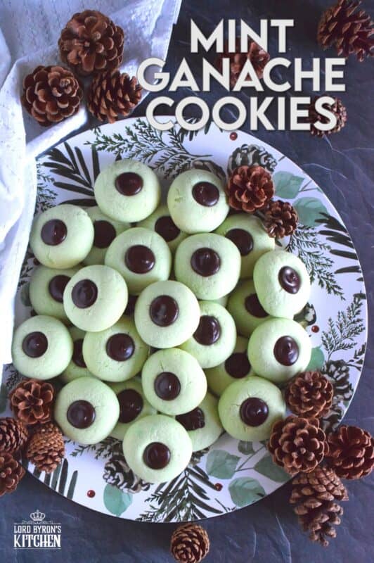 Mint Ganache Cookies are not only beautiful and tinted pastel green, they are deliciously flavoured with mint and topped with a silky, smooth, creamy mint ganache.  Unlike most ganache recipes, this one is prepared with butter, which keeps it shiny and velvety! #mint #ganache #thumbprint #christmascookies