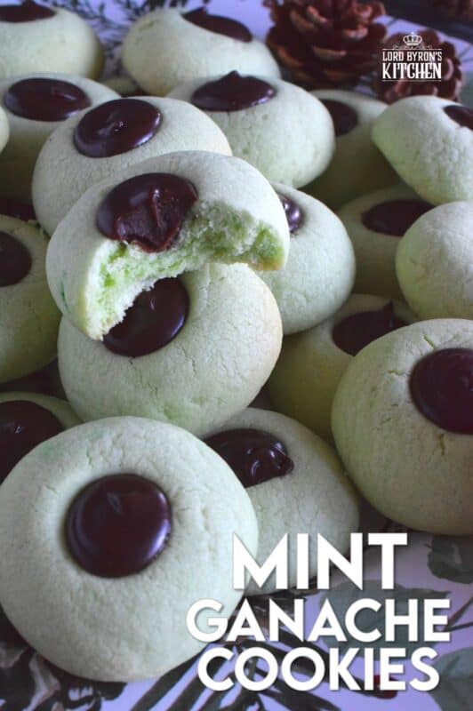 Mint Ganache Cookies are not only beautiful and tinted pastel green, they are deliciously flavoured with mint and topped with a silky, smooth, creamy mint ganache.  Unlike most ganache recipes, this one is prepared with butter, which keeps it shiny and velvety! #mint #ganache #thumbprint #christmascookies