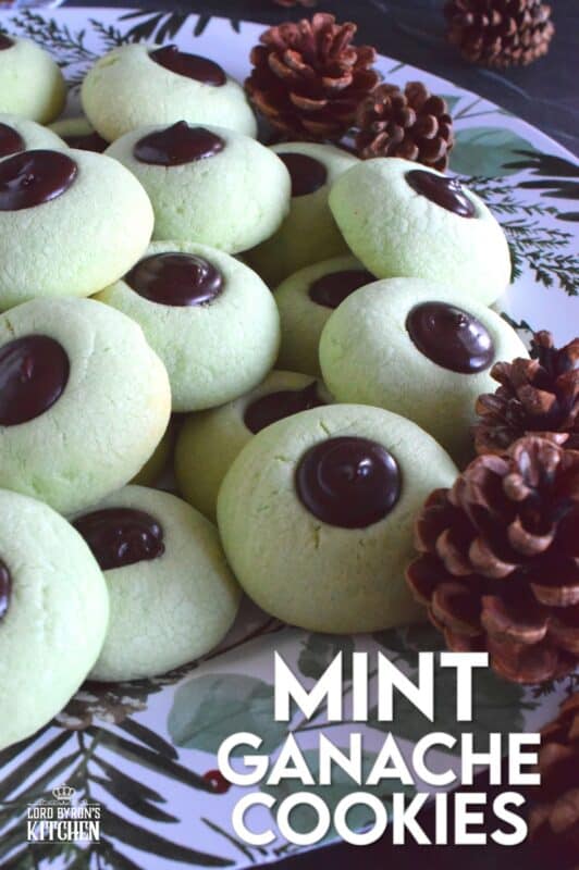 Mint Ganache Cookies are not only beautiful and tinted pastel green, they are deliciously flavoured with mint and topped with a silky, smooth, creamy mint ganache.  Unlike most ganache recipes, this one is prepared with butter, which keeps it shiny and velvety! #mint #ganache #thumbprint #christmascookies