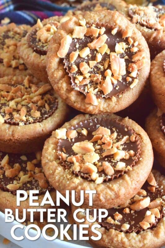 Thumbprint-style cookies are very popular at Christmastime, so why not over-stuff them with a full-sized Peanut Butter Cup? These cookies are so easy to make and are baked in muffin tins! Push in the peanut butter cup and top with chopped peanuts for more texture and flavour! #peanutbutter #reeses #cookies #thumbprint