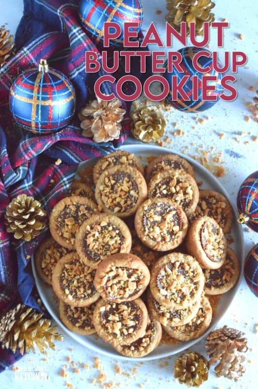 Thumbprint-style cookies are very popular at Christmastime, so why not over-stuff them with a full-sized Peanut Butter Cup? These cookies are so easy to make and are baked in muffin tins! Push in the peanut butter cup and top with chopped peanuts for more texture and flavour! #peanutbutter #reeses #cookies #thumbprint