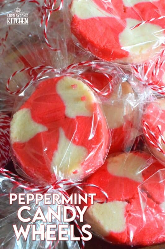 The perfect gift-giving cookie, Peppermint Candy Wheels are individually wrapped in cellophane and tied with a festive string. They may look impressive and maybe even tedious and time consuming, but these cookies really couldn't be easier! And besides, whomever you share these with will certainly appreciate the effort! #peppermint #cookies #candies #redandwhite