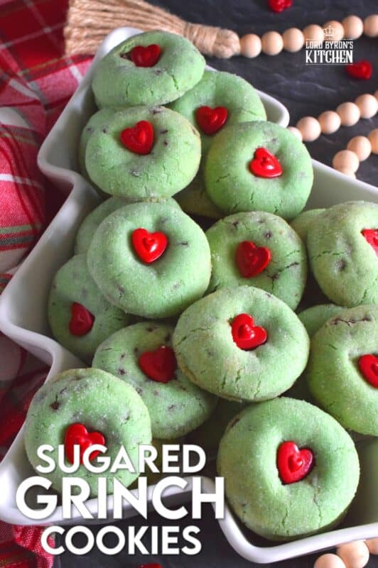 Grinch-themed confections are very popular at Christmastime especially with kids! But, these Sugared Grinch Cookies will appeal to everyone! With a sweet, sugary coating, these thick, puffy cookies are loaded with milk chocolate too! And, despite the fact that the Grinch's heart was small, I've used the biggest red candy heart I could find! #grinch #baking #cookies #christmas #heart