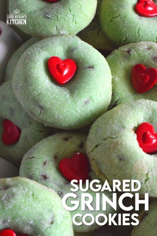Grinch-themed confections are very popular at Christmastime especially with kids! But, these Sugared Grinch Cookies will appeal to everyone! With a sweet, sugary coating, these thick, puffy cookies are loaded with milk chocolate too! And, despite the fact that the Grinch's heart was small, I've used the biggest red candy heart I could find! #grinch #baking #cookies #christmas #heart