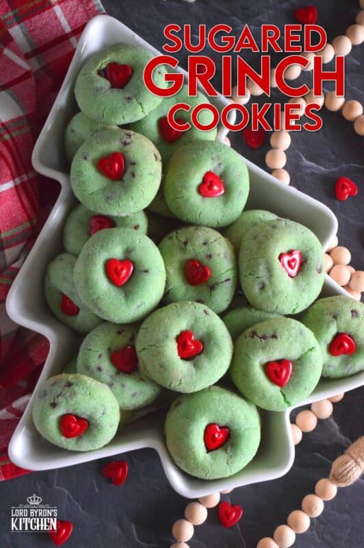 Grinch-themed confections are very popular at Christmastime especially with kids! But, these Sugared Grinch Cookies will appeal to everyone! With a sweet, sugary coating, these thick, puffy cookies are loaded with milk chocolate too! And, despite the fact that the Grinch's heart was small, I've used the biggest red candy heart I could find! #grinch #baking #cookies #christmas #heart
