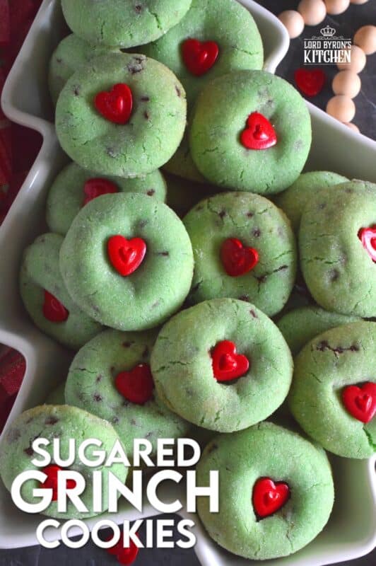 Grinch-themed confections are very popular at Christmastime especially with kids! But, these Sugared Grinch Cookies will appeal to everyone! With a sweet, sugary coating, these thick, puffy cookies are loaded with milk chocolate too! And, despite the fact that the Grinch's heart was small, I've used the biggest red candy heart I could find! #grinch #baking #cookies #christmas #heart