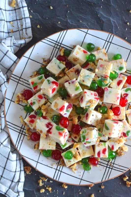 This no-bake fudge recipe is packed full of red and green candied cherries and chopped toasted walnuts. Made with melted white chocolate and canned sweetened condensed milk, Walnut Fruitcake Fudge is super easy and fast to make and tastes delicious too! #fudge #candied #cherries #nobake #fruitcake