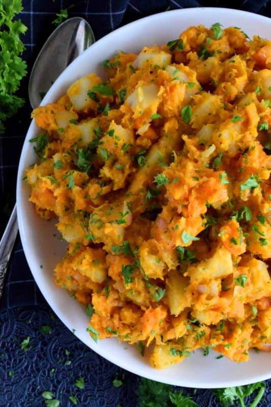 In this recipe, russet and sweet potatoes are combined with aromatics like garlic and onion to create a savoury and sweet rustic side dish. Freshly grated nutmeg is the key to making this dish even better! And, even though a skillet hash is a common family favourite, this dish could easily compete with any favourite holiday side! #sweetpotatoes #hash #skillet #vegetable #vegetarian #sidedish #thanksgiving