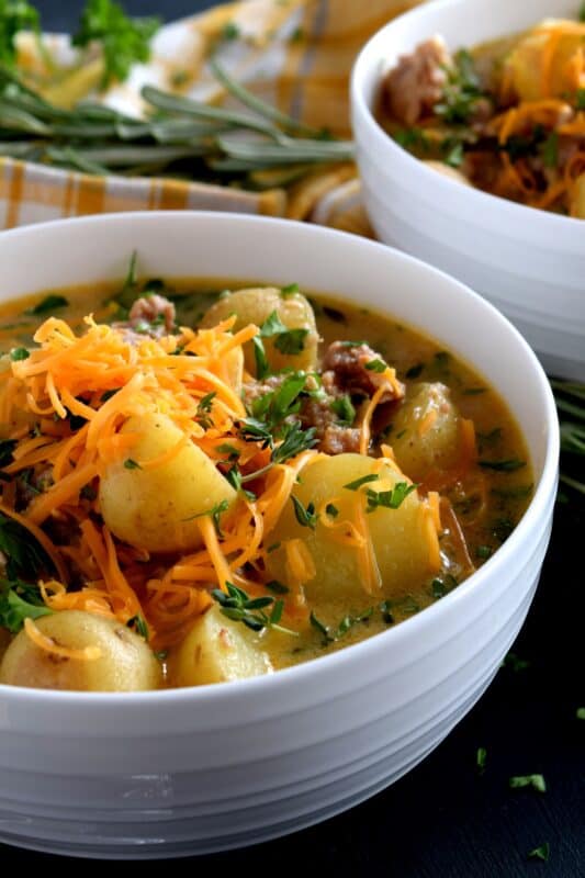 A savoury and hearty chowder which satisfies the cold weather hunger, Italian Sausage and Potato Chowder is flavourful and filling; you're going to love this recipe! Crumbled bacon or shredded cheddar cheese on top (or both!) is a great way to serve this dish! #sausage #italiansausage #chowder #potatosoup #cheese