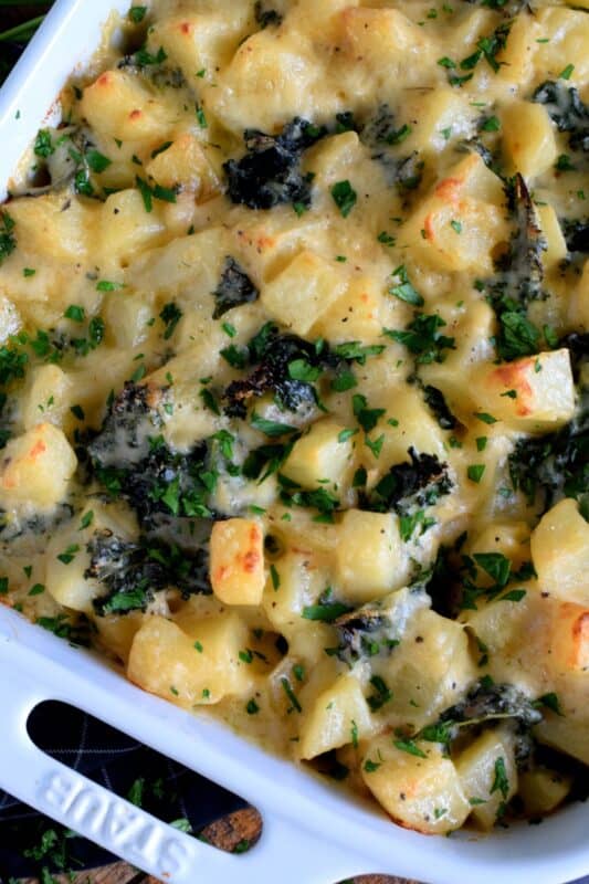 Kale is not usually associated with comfort food, but when it is combined with potatoes in a béchamel sauce and baked in the oven until it becomes golden and bubbly; Potato and Kale Gratin is most certainly the most comforting of comfort foods! #kale #gratin #casserole #potato #thanksgiving