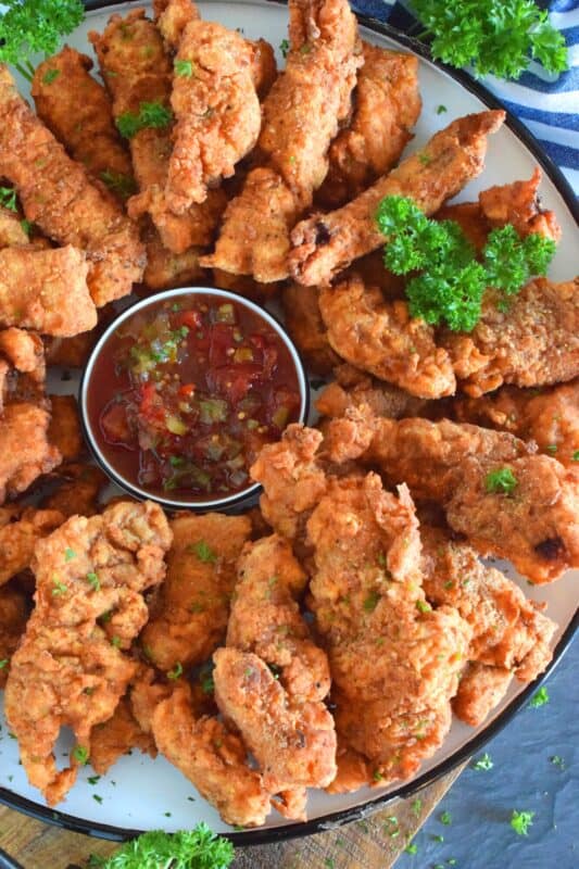 Steak is marinated in buttermilk and seasonings to tenderize and flavour before being double coated in a light batter. The steak is fried until golden and crunchy on the outside but is still moist and tender on the inside. Chicken Fried Steak Fingers have the flavour and crunch of fried chicken but with steak instead! #steakfingers #chickenfried #steak #ribeye #fingers #deepfried