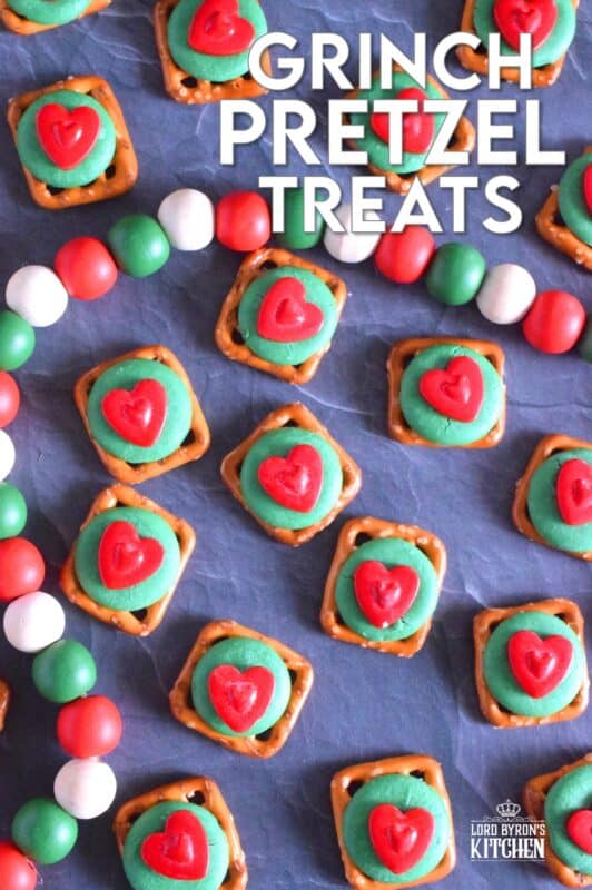 Oftentimes, these types of snacks are prepared with a Hershey's Kiss or a Rolo chocolate candy. But, Grinch Pretzel Treats needed something green and red, so the obvious choice was to top the pretzels with a green candy melt and a big shiny red heart. Aren't they cute!? #grinch #pretzel #treats