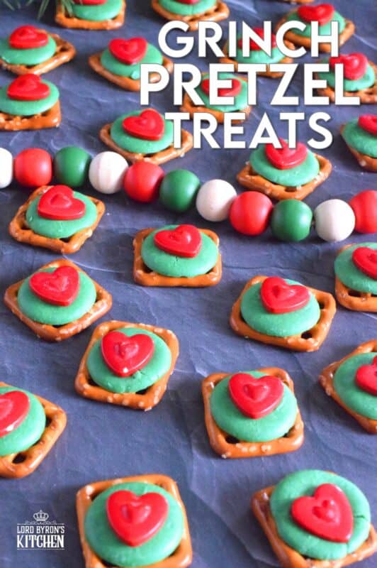Oftentimes, these types of snacks are prepared with a Hershey's Kiss or a Rolo chocolate candy. But, Grinch Pretzel Treats needed something green and red, so the obvious choice was to top the pretzels with a green candy melt and a big shiny red heart. Aren't they cute!? #grinch #pretzel #treats
