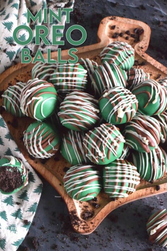 Otherwise known as truffles, these Mint Oreo Balls are prepared with crushed mint-flavoured Oreos and cream cheese. They are dipped in melted green candy melts and drizzled with milk and white melted chocolate. They're bright, beautiful, festive, and delicious! #oreo #truffles #balls #nobake #christmas