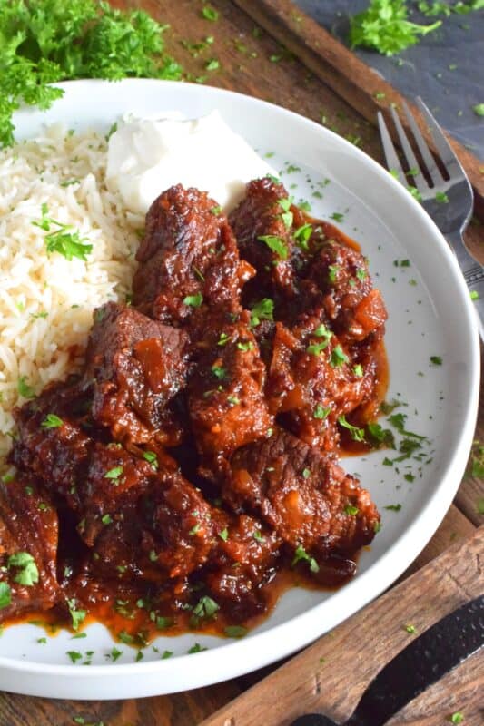 Moist and tender beef is braised in a rich and sweet tomato-based sauce with onion, garlic, chipotle in adobo sauce, and brown sugar. The secret to absolutely delicious Braised Mexican Beef is allowing the meat to cook for hours in a pot with a heavy lid. Braising cannot be rushed and patience is greatly rewarded with just one bite! #mexican #braised #beef #brisket