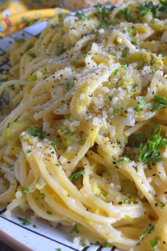 Sweet oniony leeks are paired with garlic, parmesan, and butter in this rustic and delicious Creamy Leek and Garlic Spaghetti. This recipe, although vegetarian, is hearty and filling and can be on your dinner table in thirty minutes or less! #leek #spaghetti #pasta #vegetarian