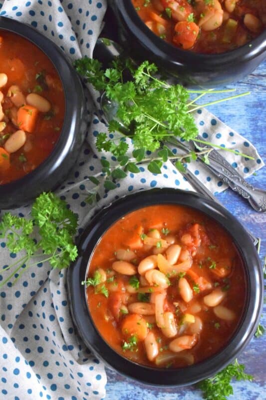 This soup is thick, hearty, and filling! Tomato Vegetable Soup is in fact more like a stew than a soup! It has a dense, homestyle tomato flavour combined with the creaminess of tender white beans, and is paired with lots of fresh and good-for-you vegetables too. Yummy! Sounds good to me! #beans #soup #vegetables #tomato