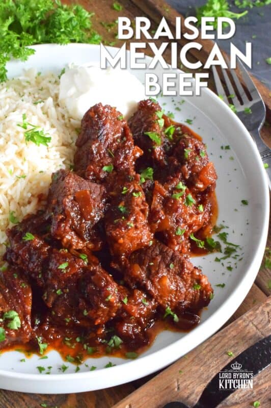 Moist and tender beef is braised in a rich and sweet tomato-based sauce with onion, garlic, chipotle in adobo sauce, and brown sugar. The secret to absolutely delicious Braised Mexican Beef is allowing the meat to cook for hours in a pot with a heavy lid. Braising cannot be rushed and patience is greatly rewarded with just one bite! #mexican #braised #beef #brisket