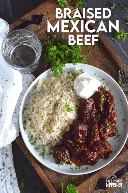 Moist and tender beef is braised in a rich and sweet tomato-based sauce with onion, garlic, chipotle in adobo sauce, and brown sugar. The secret to absolutely delicious Braised Mexican Beef is allowing the meat to cook for hours in a pot with a heavy lid. Braising cannot be rushed and patience is greatly rewarded with just one bite! #mexican #braised #beef #brisket