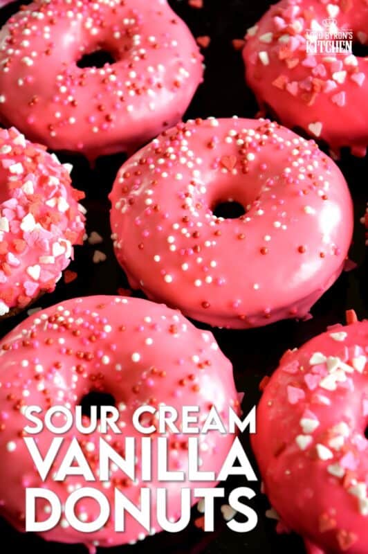 Sour Cream Vanilla Glazed Donuts are baked to perfection in only 10 minutes! They are soft and moist and very cake-like inside. Share these with your favourite valentine or save them all for yourself! #valentines #recipes #pink #donuts #baked