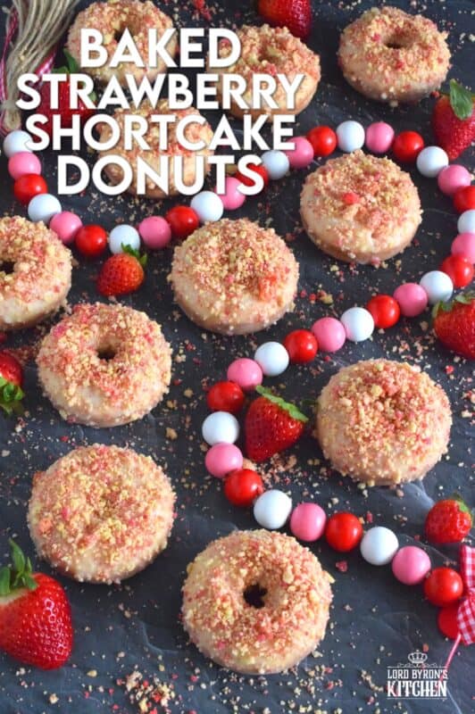 Baked Strawberry Shortcake Donuts are prepared with homemade strawberry shortcake crumbs! Baked to perfection in only 10 minutes, glazed and topped with more shortcake crumbs, these donuts are super soft and moist and very cake-like inside. Share these with your favourite valentine or save them all for yourself! #strawberry #donuts #doughnuts #valentine