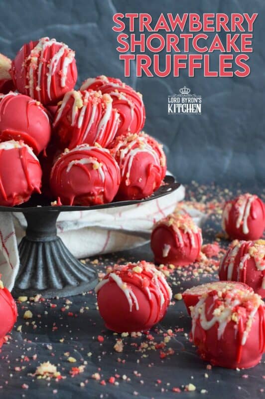 Prepared with crushed vanilla-flavoured Golden Oreos, cream cheese, and homemade strawberry shortcake crumbs, these Strawberry Shortcake Truffles are dipped in melted red candy melts and drizzled with white melted chocolate. They’re beautifully bold and bright, and delicious too! #truffles #valentines #nobake #pink #candy