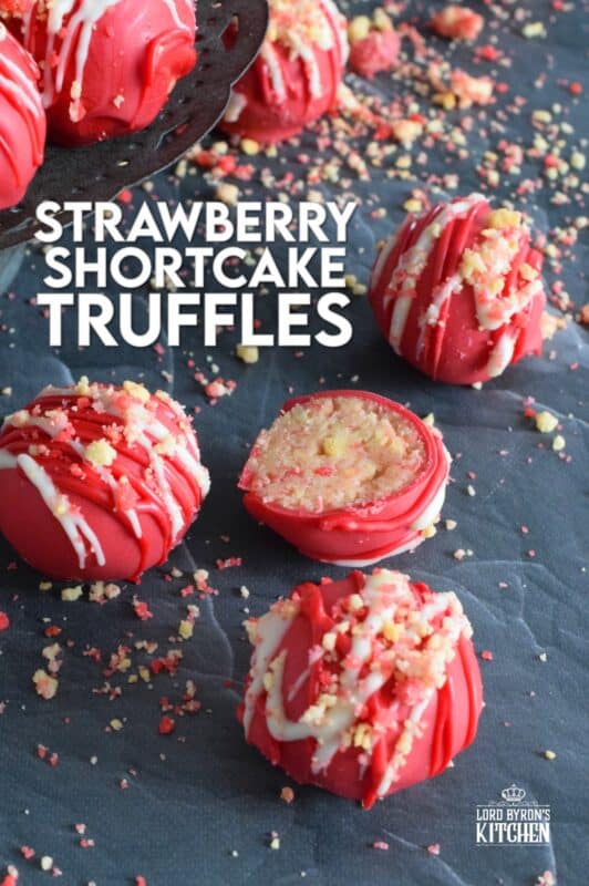Prepared with crushed vanilla-flavoured Golden Oreos, cream cheese, and homemade strawberry shortcake crumbs, these Strawberry Shortcake Truffles are dipped in melted red candy melts and drizzled with white melted chocolate. They’re beautifully bold and bright, and delicious too! #truffles #valentines #nobake #pink #candy