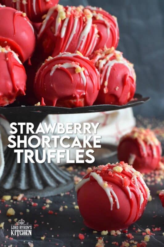 Prepared with crushed vanilla-flavoured Golden Oreos, cream cheese, and homemade strawberry shortcake crumbs, these Strawberry Shortcake Truffles are dipped in melted red candy melts and drizzled with white melted chocolate. They’re beautifully bold and bright, and delicious too! #truffles #valentines #nobake #pink #candy