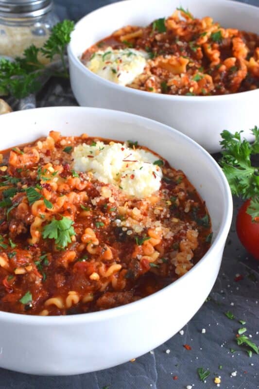 Hearty and beefy and topped with fresh mozzarella cheese, this Easy Lasagna Soup is a perfect meal for a chilly wintery night supper. Easy to prepare in about thirty minutes, and packed with familiar homestyle baked lasagna flavours. Kick it up a notch with a good sprinkling of chili flakes to add extra warmth and heat! #lasagna #soup #tomato #mozzarella #hearty #beef