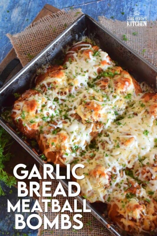 Garlic Bread Meatball Bombs are hollowed out dinner rolls which have been liberally smeared with homemade garlic butter. Each roll is stuffed with a meatball and sauce, then topped with cheese. Baked to a bubbling, gooey perfection, these bombs are the bomb! #meatballs #sliders #dinnerrollrecipes #bombs #meatballrecipes #familyrecipes #garlicbread