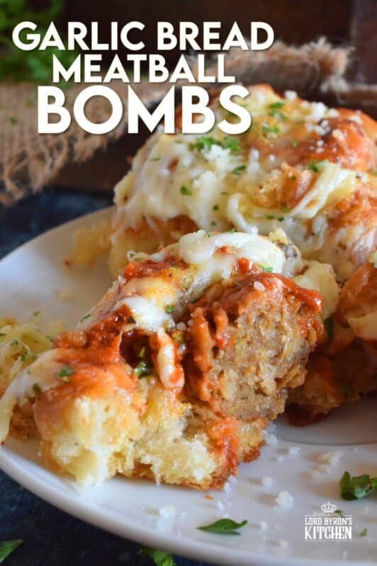 Garlic Bread Meatball Bombs are hollowed out dinner rolls which have been liberally smeared with homemade garlic butter. Each roll is stuffed with a meatball and sauce, then topped with cheese. Baked to a bubbling, gooey perfection, these bombs are the bomb! #meatballs #sliders #dinnerrollrecipes #bombs #meatballrecipes #familyrecipes #garlicbread