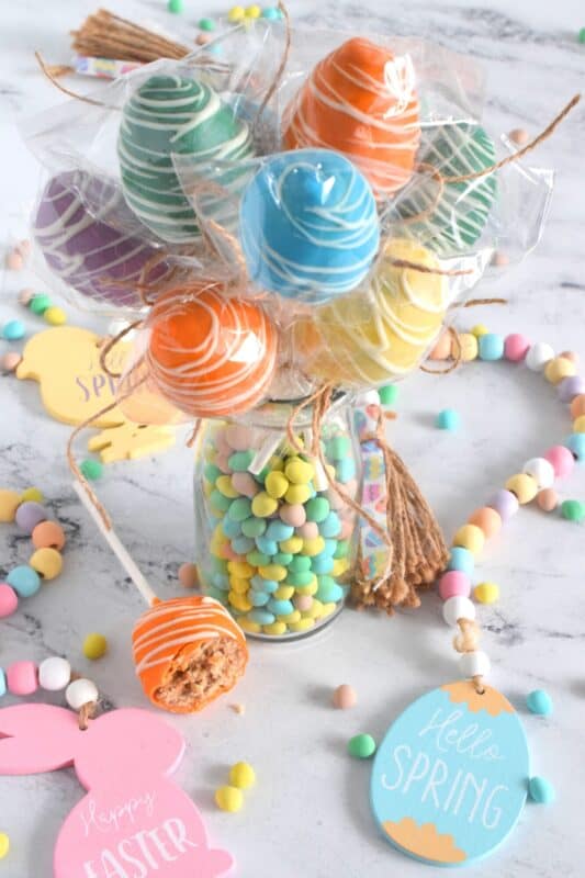 Prepared with a homemade chocolate mini egg cake center, dipped in spring-like, pastel-coloured candy melts, and drizzled with melted white chocolate, Easter Mini Egg Cake Pops are fun to make and are super fun to eat too! So much cheaper than store-bought cake pops, these are almost too delicious to share! #easter #cakepops #minieggs