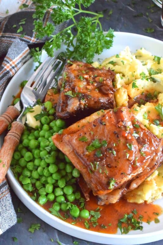 Saucy and savoury, Instant Pot Beef Short Ribs are tender and flavourful - just the way ribs should be!  Take the long, slow-braising, stovetop cooking method out of the equation with this faster instant pot recipe! The braising liquid easily doubles as a delicious gravy too! #instantpot #ribs #shortribs #beef #beefribs
