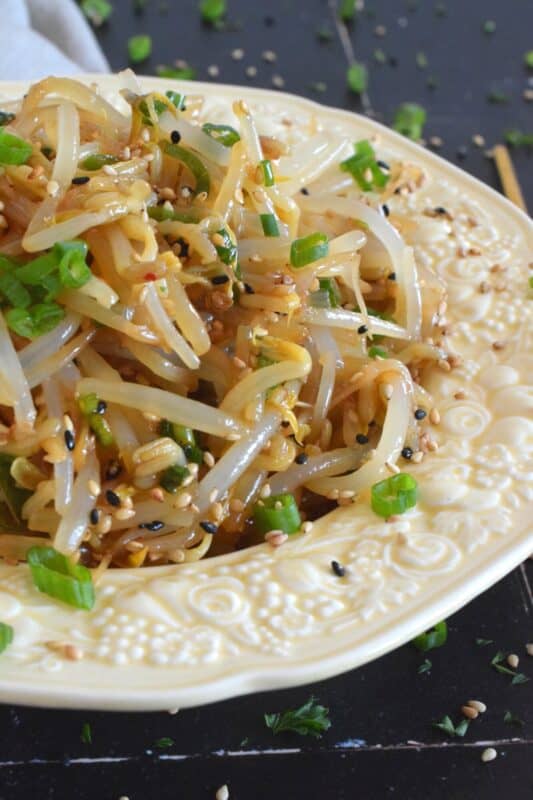 Served warm or cold, Sesame Bean Sprouts Salad is a crunchy and delicious side that can be prepared in less than 10 minutes! Blanched sprouts are tossed in a savoury, earthy, salty sauce made with soy sauce, sesame oil, minced garlic, and lots of fresh green onions. #beansprouts #salad #sesame