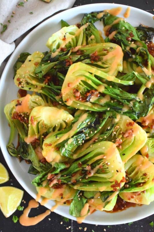 A delicious, quick and easy side dish, Soy Sesame Bok Choy with an optional Spicy Mayo takes less than 15 minutes from start to finish!  Seasoned and sauced with a savoury, salty, and slightly sour homemade dressing, this side is one you will want to make over and over again! #bokchoy #asian #sesame #sides