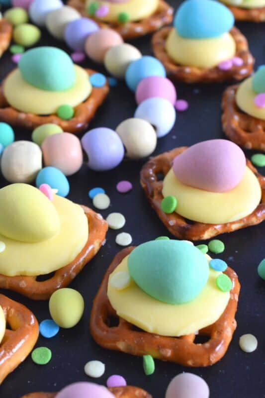 Oftentimes, these types of snacks are prepared with a large chocolate center, but to keep these Chickadee Pretzel Snack Bites as Easter-like as possible, use a yellow candy melt wafer instead! Top them with a Cadbury Mini Egg and festive sprinkles! Not only are they super cute, but they're also super delicious! #easter #pretzel #treats #snacks