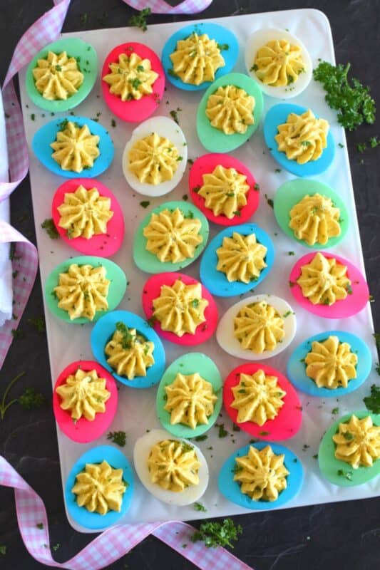 Easter isn't Easter without boiled eggs, so why not have some fun and make a batch of very Easter-y and very colourful Deviled Easter Eggs!? Don't hide these around the house and give the Easter Bunny all the credit! #deviledeggs #eastereggs #easter #deviled #boiledeggs #dyedeggs