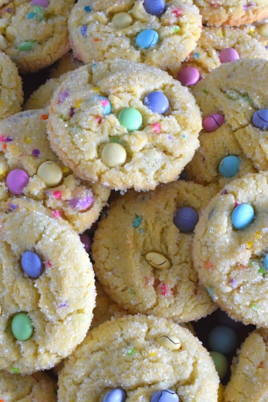 Candy-coated chocolate and pastel sprinkles are very popular when baking for Easter, especially if you're baking for kids!  However, the kids are going to have to share with the adults, because when it comes to these Easter Funfetti Cookies, they appeal to everyone! With a sweet, sugary coating, these soft and chewy cookies are loaded with lots of colour and flavour!  It's hard to eat just one of these! #easter #funfetti #candy #sprinkles #pastel #cookies