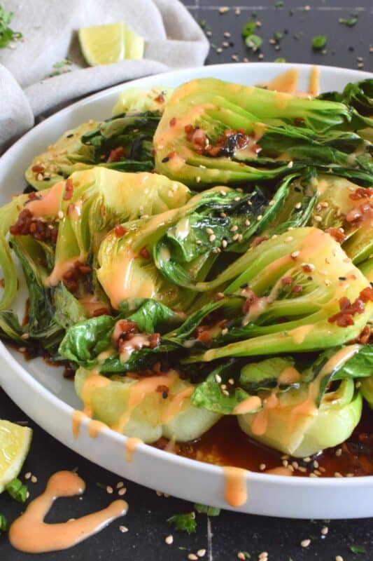 A delicious, quick and easy side dish, Soy Sesame Bok Choy with an optional Spicy Mayo takes less than 15 minutes from start to finish!  Seasoned and sauced with a savoury, salty, and slightly sour homemade dressing, this side is one you will want to make over and over again! #bokchoy #asian #sesame #sides