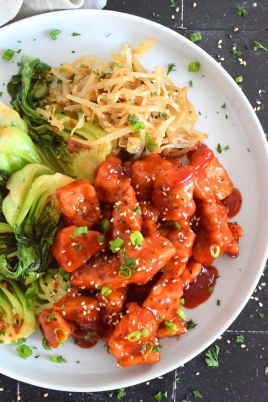 Extra firm tofu is seasoned and baked until lightly crispy on the outside with a slightly chewy, meatier inside. It is then tossed in a homemade sweet and sour sauce which makes this one of the most delicious ways to enjoy a baked tofu dish! If you think you don't like tofu, you obviously have not tried this recipe! #tofu #sweetandsour #meatless