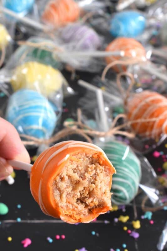 Prepared with a homemade chocolate mini egg cake center, dipped in spring-like, pastel-coloured candy melts, and drizzled with melted white chocolate, Easter Mini Egg Cake Pops are fun to make and are super fun to eat too! So much cheaper than store-bought cake pops, these are almost too delicious to share! #easter #cakepops #minieggs