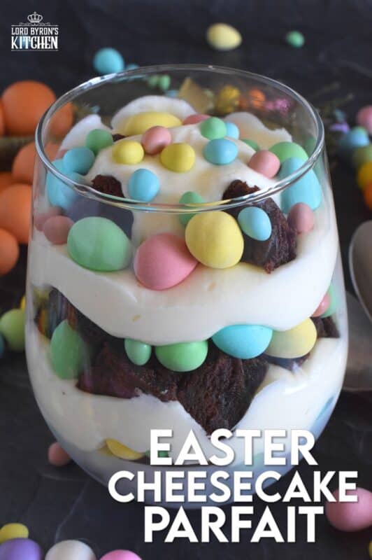 Crumbled brownies are layered with chocolate mini eggs and a homemade cream cheese filling in this Easter Cheesecake Parfait recipe. Easily prepare everything a few days ahead of time and assemble the parfaits when ready to serve. Make extra because these are deliciously addictive! #easter #dessert #parfait #brownie #minieggs